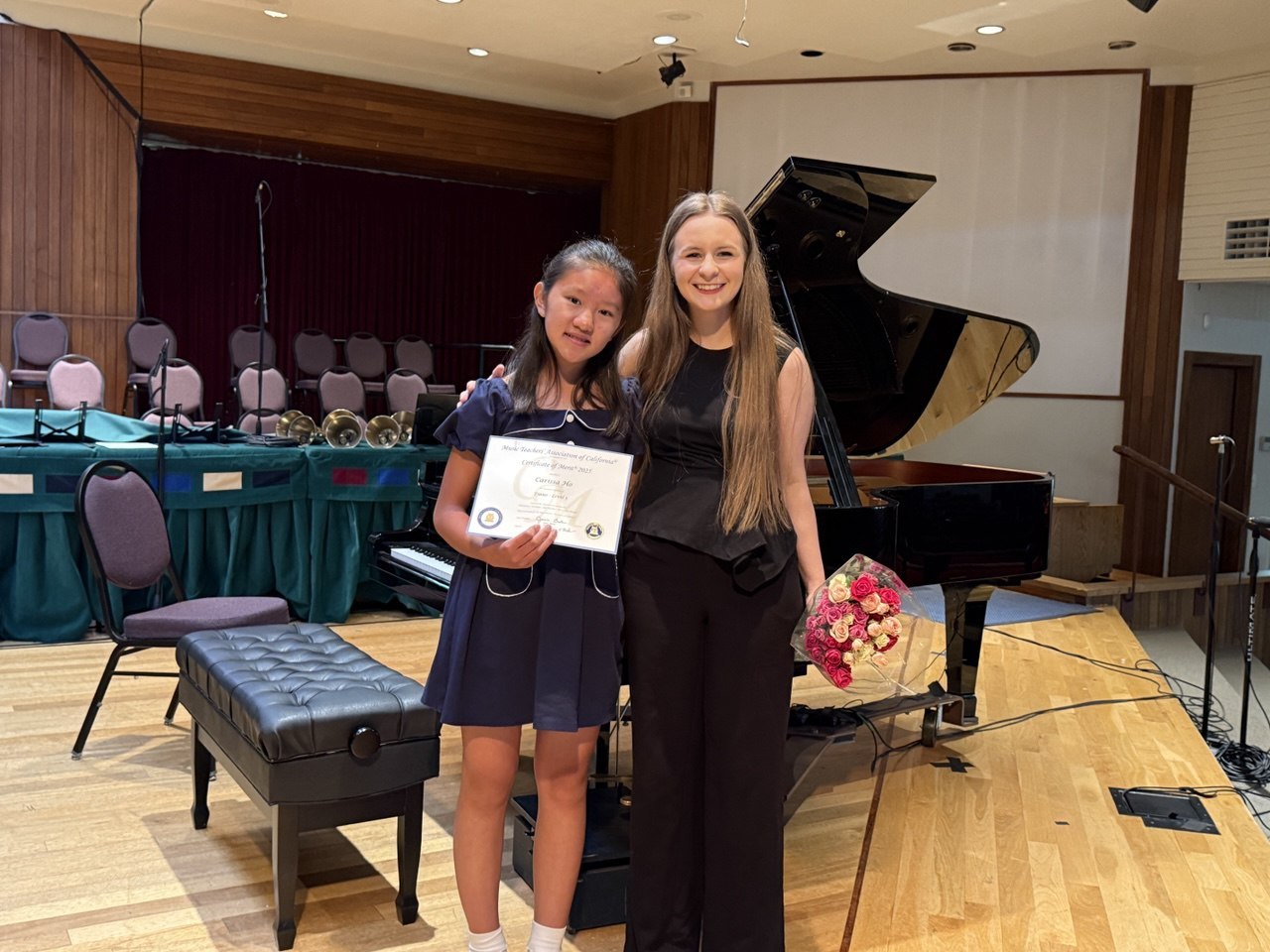 Anastasiia with a piano student following a musical performance